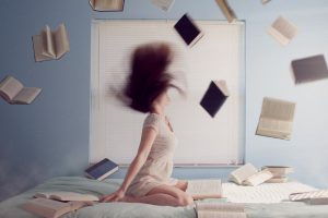 lady throwing books in air