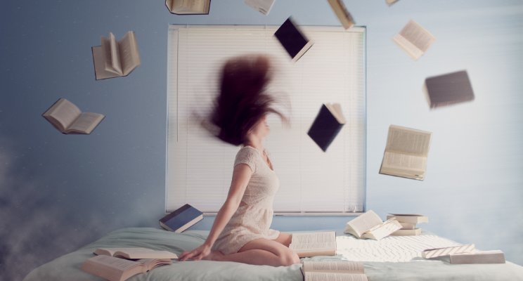 lady throwing books in air